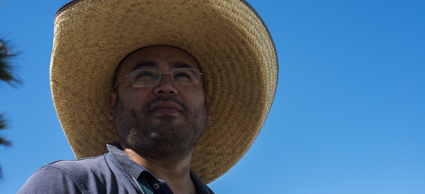 Enrique Chiu, a Tijuana-based artist, pauses for a moment while preparing to paint the fencing of the wall between the U.S. and Mexico at Friendship Park in Tijuana on Oct. 7, 2017. Chiu is a U.S.-trained artist and has dedicated nearly a year to painting murals on the southern side of the border wall.
