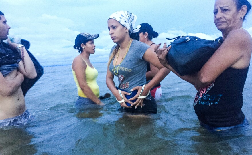 At dawn, Liset and Marta prepare to board a boat in Colombia as they near the border with Panama.