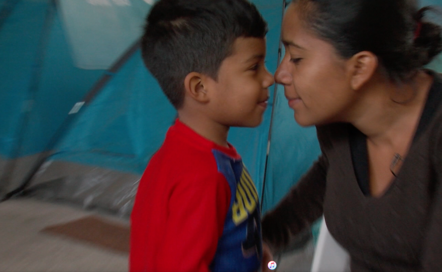 Olivia Caceres and her son Andree play in a migrant shelter in northern Mexico, Nov. 4, 2017. 