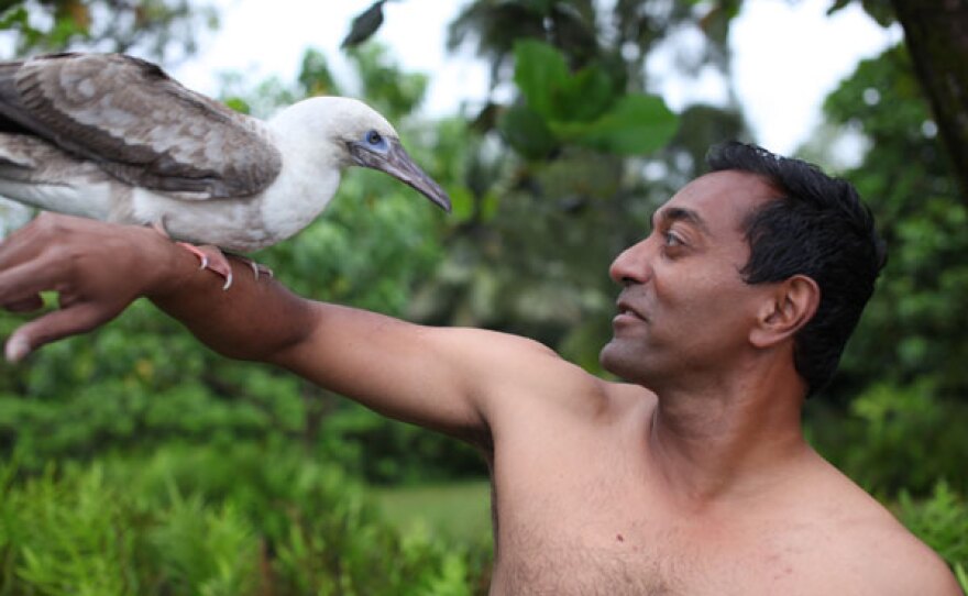 M. Sanjayan with a red-footed boobie bird on his arm.