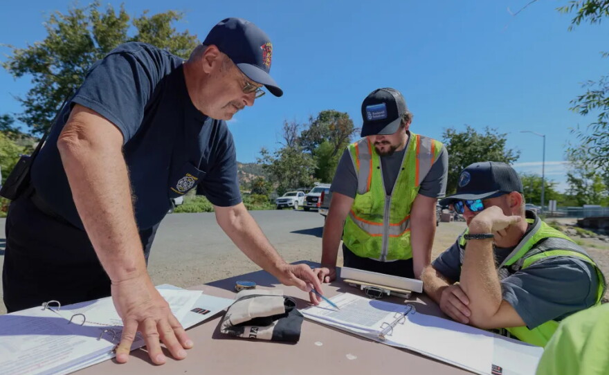 Lake County Fire Chief Willie Sapeta, left, during a training session for crews to learn how to use remote hydrants at Clearlake Oaks on Aug. 27, 2026.