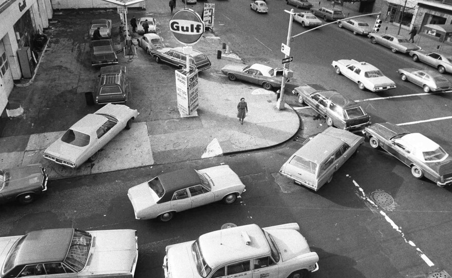 In this Dec. 23, 1973, file photo, cars line up in two directions at a gas station in New York City. It was a time when the country was experiencing surging energy prices.