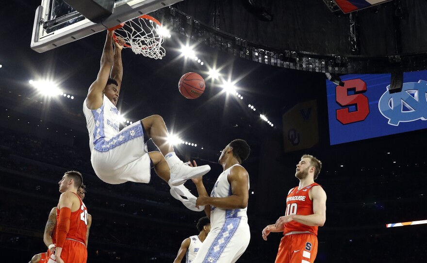 North Carolina's Isaiah Hicks (4) dunks during the first half of the NCAA Final Four tournament college basketball semifinal game against Syracuse, Saturday, April 2, in Houston.