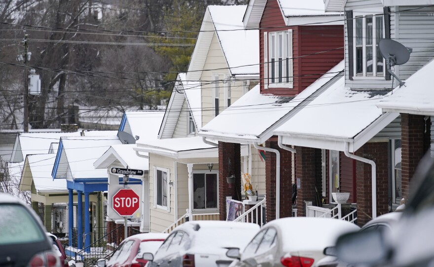 Snow blankets a row of homes after a snowstorm in Bellevue, Ky., on Friday.