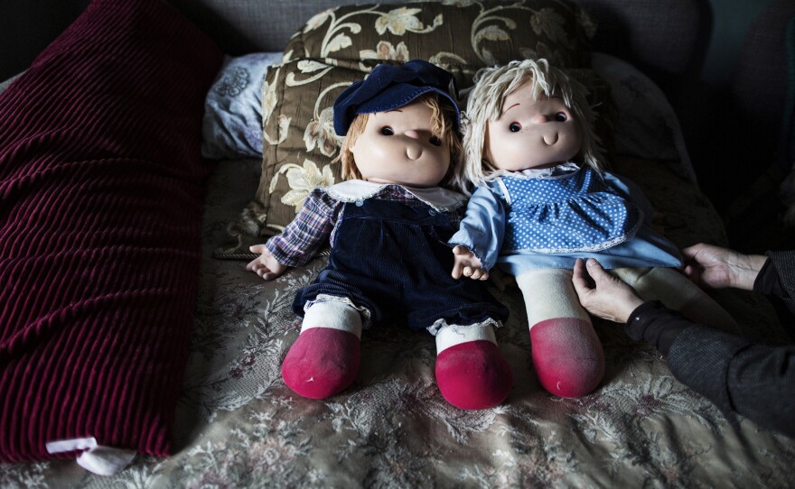 Rosemary adjusts one of Natalie's many dolls.