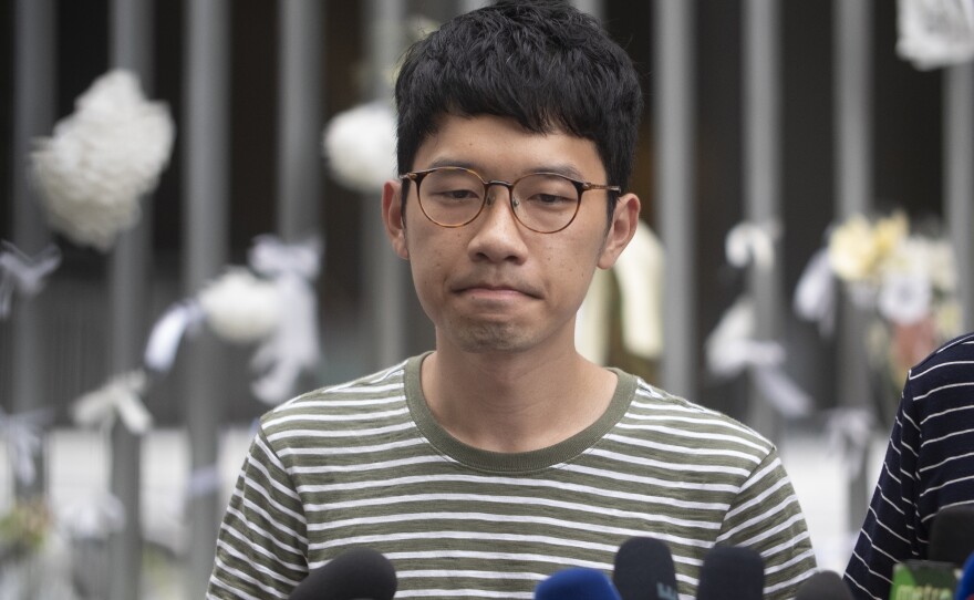 Pro-democracy party activist Nathan Law speaks to the media outside Hong Kong's Legislative Council building last year.