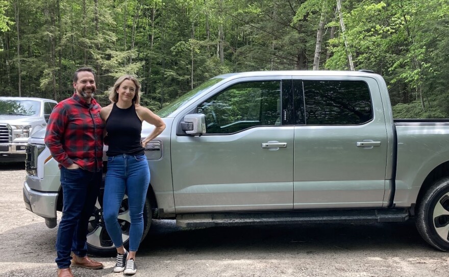 Schmidt and his wife pose with their new F-150 Lightning.