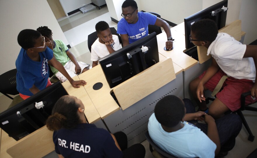 Current Morgan State students work as teaching aides and mentors.