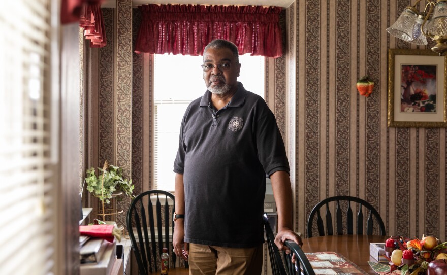 Eugene Lewis poses for a portrait in his kitchen.