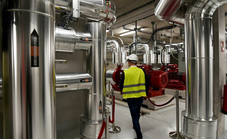 A man walks at the Thassalia marine geothermal plant. A New England energy utility is building a networked geothermal system to heat and cool 37 buildings.