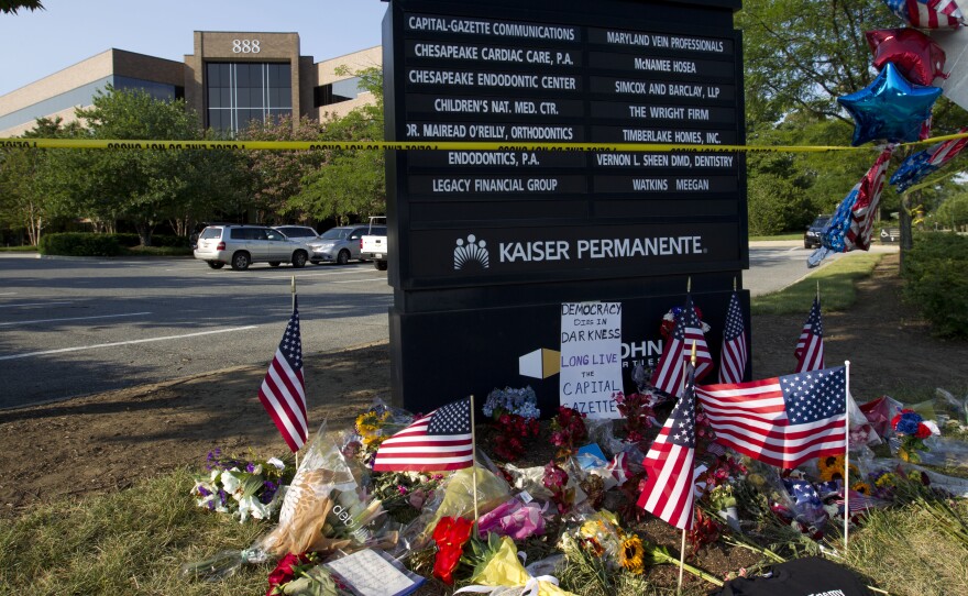 A makeshift memorial is seen outside the office building housing the Capital Gazette newsroom in Annapolis, Md., on Sunday.