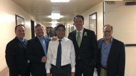 County Supervisor Nathan Fletcher with Raymond "Jay" Bariuan, center, with his coach Keith Robinson, far left, and representatives from Partnerships With Industry after the vote at the County Administration Building on May 21, 2019.