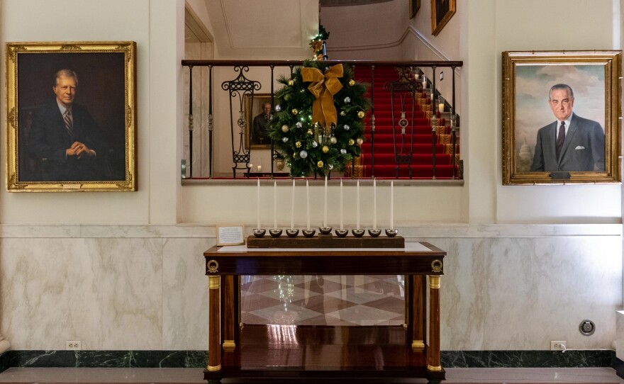 The White House Menorah can be seen in Cross Hall and is part of this year's "We The People"-themed holiday display. The Bidens will add the menorah to the permanent White House collection at a Hanukkah reception Monday evening,