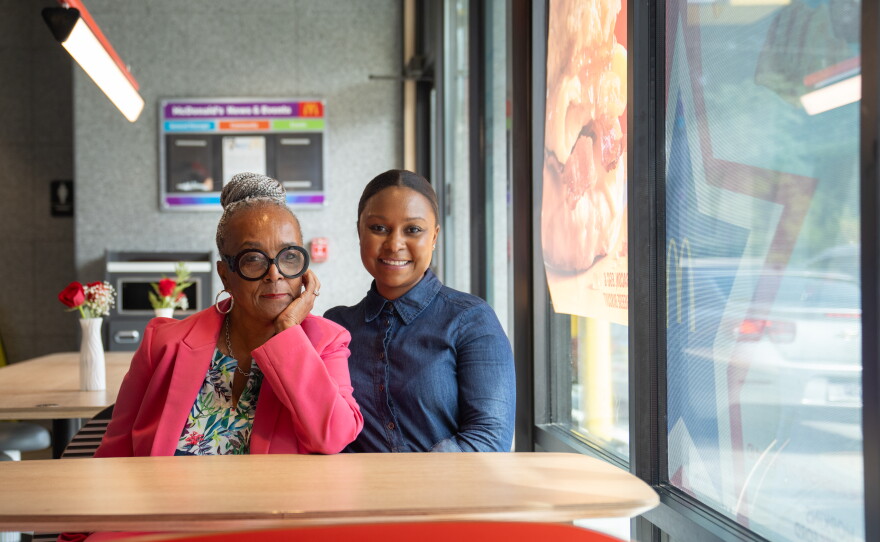 Mary Hopkins-Navies (left) and her daughter Imani Ford sit inside one of seven McDonald's restaurants they own in Prince George's County, Md.
