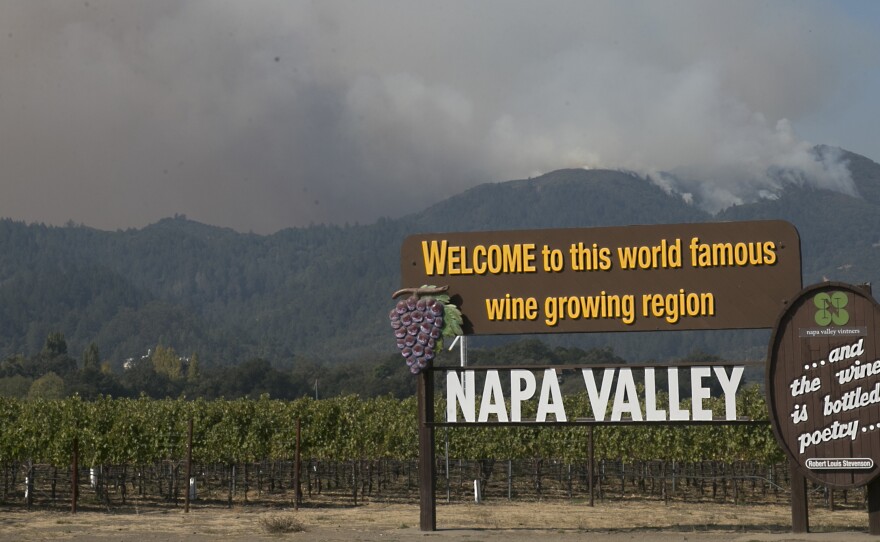 Smoke billows up from a fire burning in the mountains over the Napa Valley last October in Oakville, Calif.