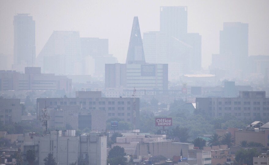 Smog blankets scyscrapers in Mexico City on March 17. The city is suffering its worst pollution in more than a decade, and cars are required to stay off the street one day a week.