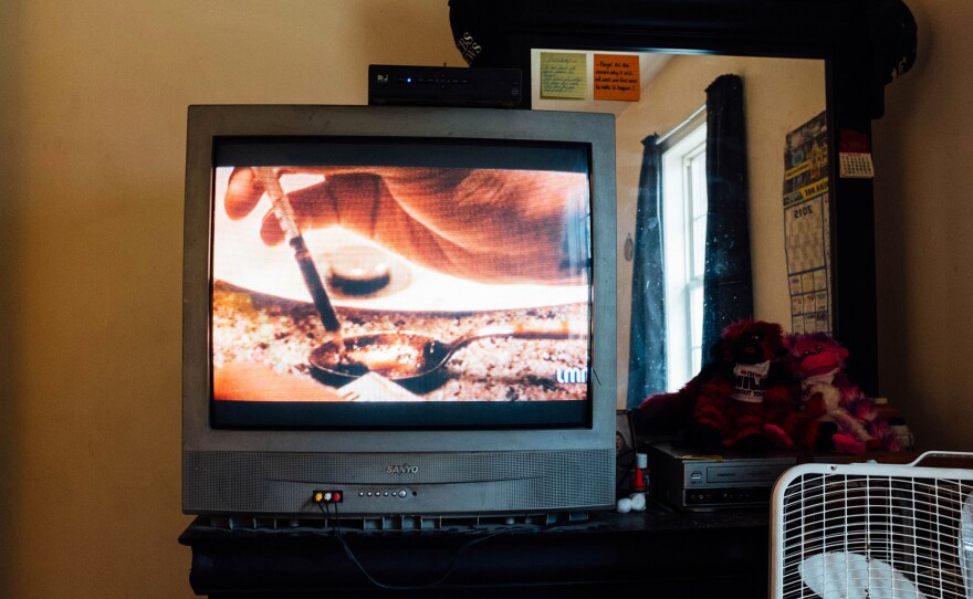 A TV commercial showing IV drug use plays in the room where Opana was injected.