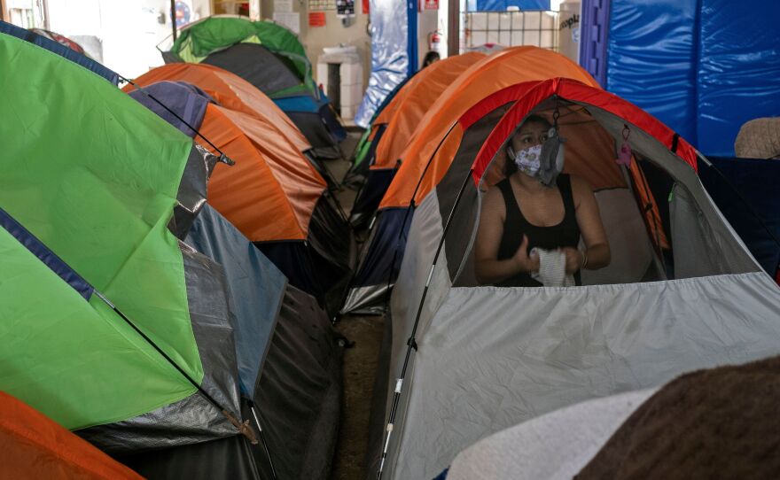 Mexican asylum seeker Eily Sanchez cleans her tent at a migrant shelter in Tijuana, Mexico, last month.