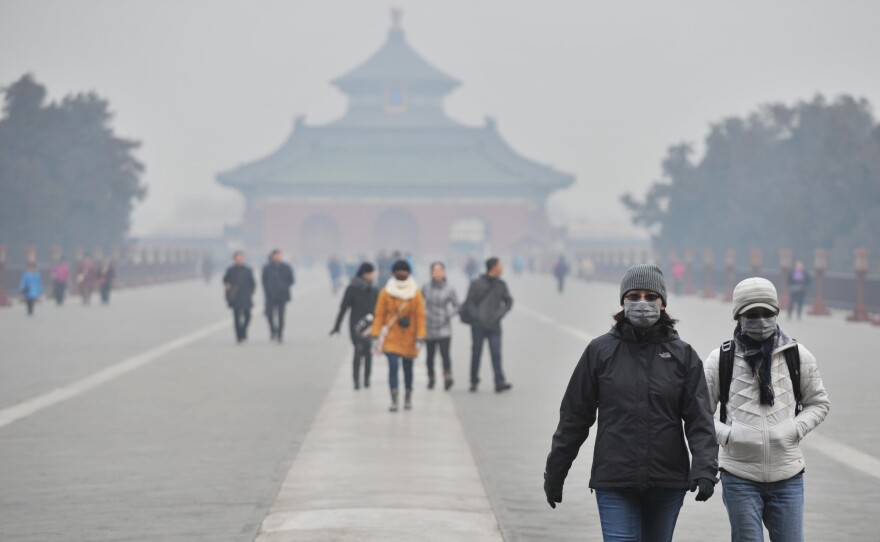 Tourists wear facial masks while visiting the Temple of Heaven Park in Beijing in January.