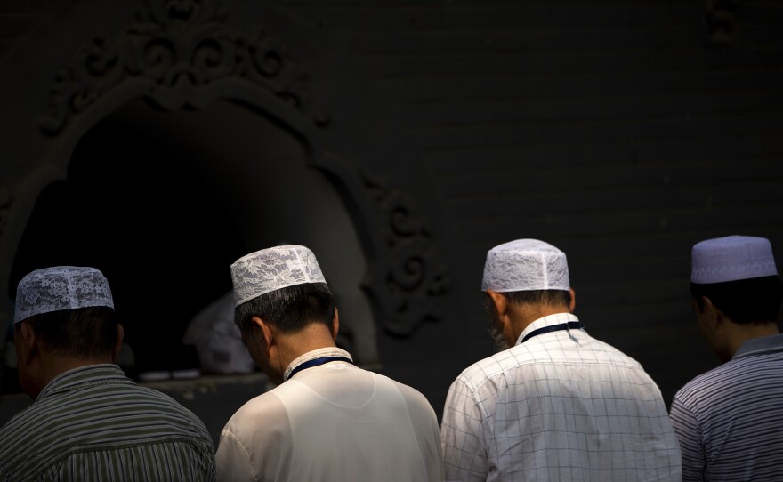 Chinese Hui Muslims pray during Eid al-Fitr prayers at Niujie Mosque in Beijing in 2015. Authorities in western China were poised to begin demolition of a mosque Friday, despite protests by members of the country's Muslim Hui ethnic minority determined to preserve the newly built structure.