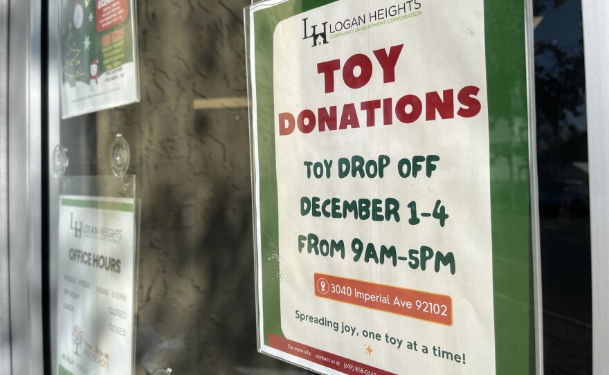 A sign about toy donation drop offs hangs on the door at Logan Heights Community Development Corporation, Dec. 2, 2025.