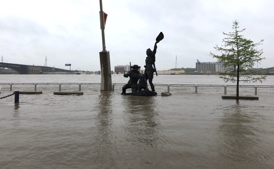 A statue of explorers Lewis and Clark is surrounded by floodwaters along the St. Louis riverfront on Thursday.