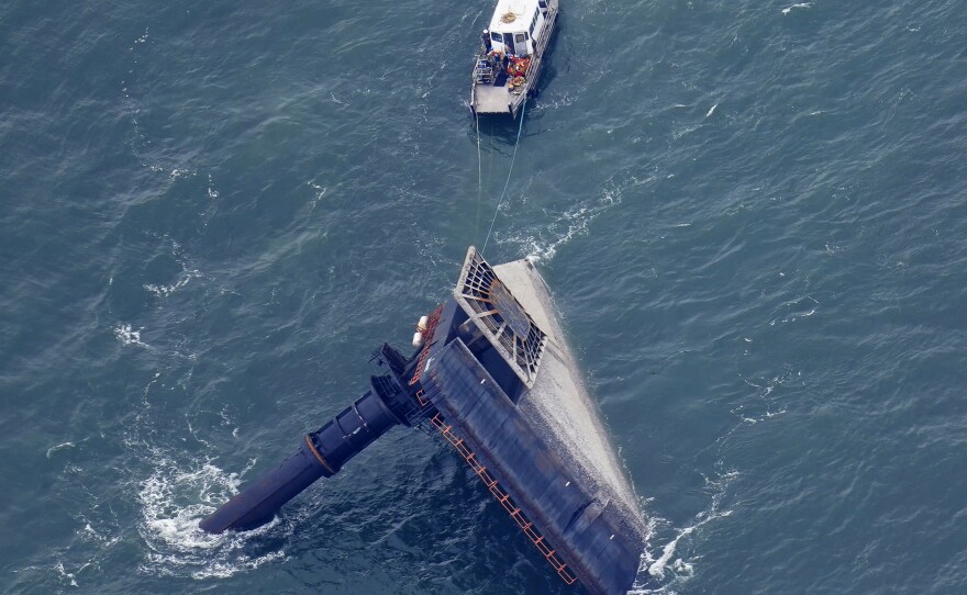 A rescue boat is seen next to the capsized lift boat Seacor Power seven miles off the coast of Louisiana in the Gulf of Mexico Sunday. The vessel capsized during a storm last Tuesday.