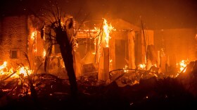 Flames consume a structure as the Lilac fire burns in Bonsall, Calif., on Friday, Dec. 8, 2017. 