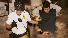 An U.S. Customs and Border Protection bike patrol agent apprehends an undocumented immigrant after he was spotted entering the country illegally June 2, 2010 in Nogales, Arizona. 