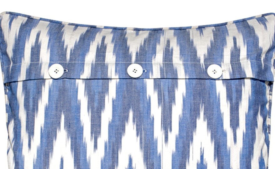 Ikat pillow by Mela Artisans. The yarn is dyed first, then woven, creating bold, zigzag patterns.
