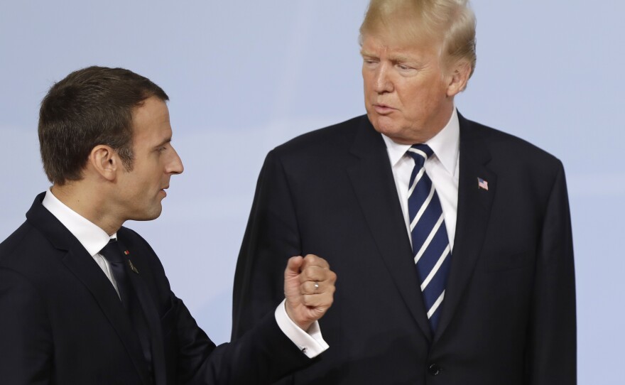 France's President Emmanuel Macron talks with U.S. President Donald Trump after the family photo on the first day of the G-20 summit in Hamburg, northern Germany, Friday, July 7, 2017. 