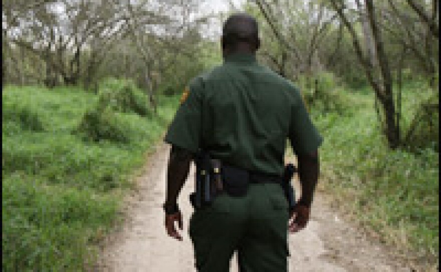 A U.S. Border Patrol officer walks near the Rio Grande river in Halinger, Texas.