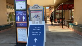 A COVID-19 sign sits out from of the Grossmont vaccination site in La Mesa, March 1, 2021. 