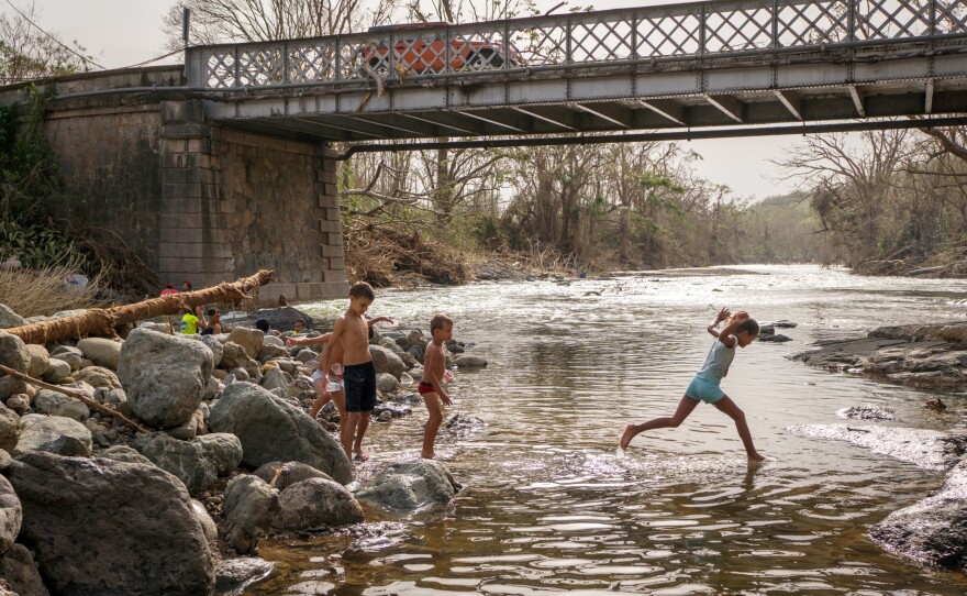 Children play in the Calabaza River in Coamo. In addition to washing up and doing laundry, some people came to the river to take a break from the post-storm cleanup