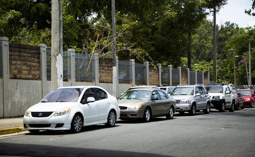 People waited to pick up meals for their children at a public school cafeteria in Vega Alta, P.R., on May 6. The island's governor initially refused to open the cafeterias, but public pressure changed her mind.