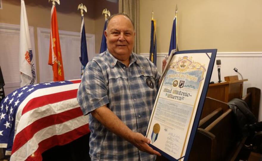 Ruben Valencia accepts a certificate from Los Angeles County Supervisors recognizing Raul Guerra's return to Southern California in this undated photo.