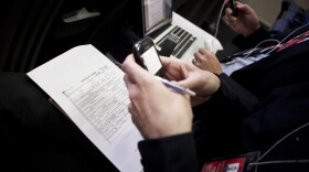 A copy of President Barack Obama's long form birth certificate sits on a reporter's lap while he works on his Blackberry in the Briefing Room of the White House April 27, 2011 in Washington, DC. 