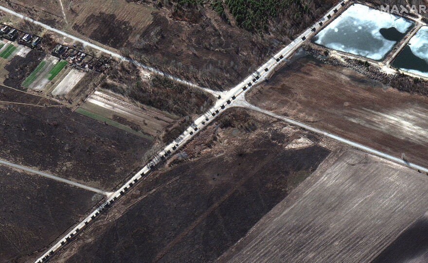 Along parts of the route, some vehicles are spaced fairly far apart while in other sections military equipment and units are traveling two or three vehicles abreast on the road north of Invankiv, Ukraine.