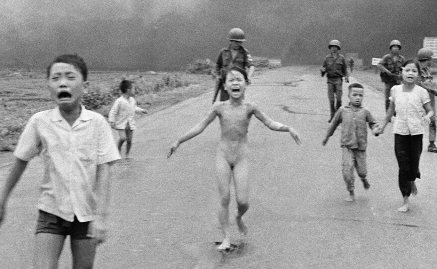 Terrified children, including 9-year-old Kim Phuc, center, flee after a South Vietnamese plane dropped a napalm bomb on June 8, 1972. The girl had ripped off her burning clothes.