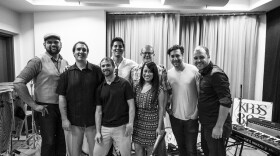 Band members of the group, The Sure Fire Soul Ensemble, pose for a picture at the KPBS studios. From left to right (front row) Jesse Audelo, Matt LaBarber, Pete Williams, Sheryll Felten, (back row) Diego Velasquez, Tim Felten, Nick Costa, Robert Dove. 
