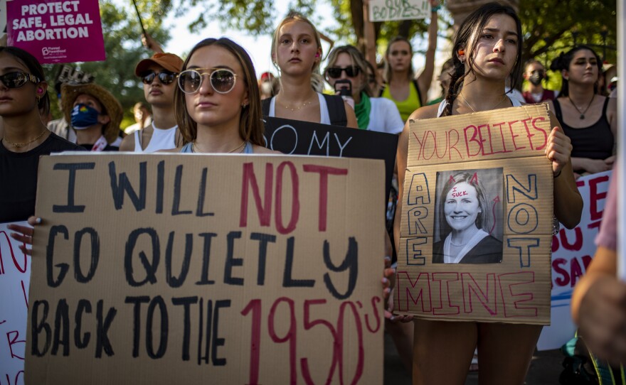 Protesters hold up signs during an abortion-rights rally on Saturday in Austin, Texas.