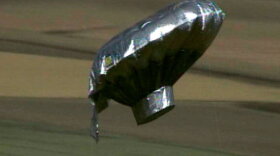 A homemade helium balloon resembling a flying saucer floats thousands of feet above Colorado. A 6-year-old boy was reportedly seen climbing inside the aircraft, but he was not found when the balloon touched down.