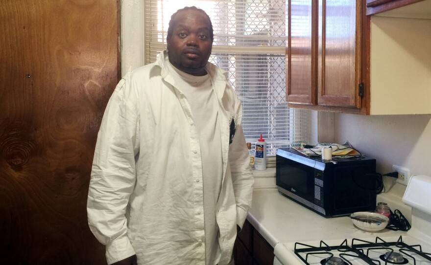 Glenn Baker, 44, stands in his Southside Chicago apartment that is paid for by a program of the University of Illinois Chicago hospital.