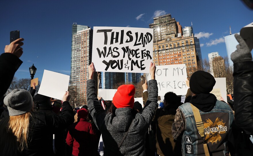 People attend an afternoon rally at Battery Park in New York City to protest President Trump's executive order.