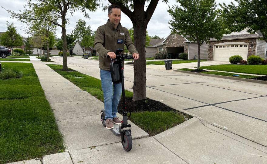 Indiana state Sen. Spencer Deery rides his electric scooter to canvass neighborhoods in his district on April 28  ahead of Indiana's primary election.