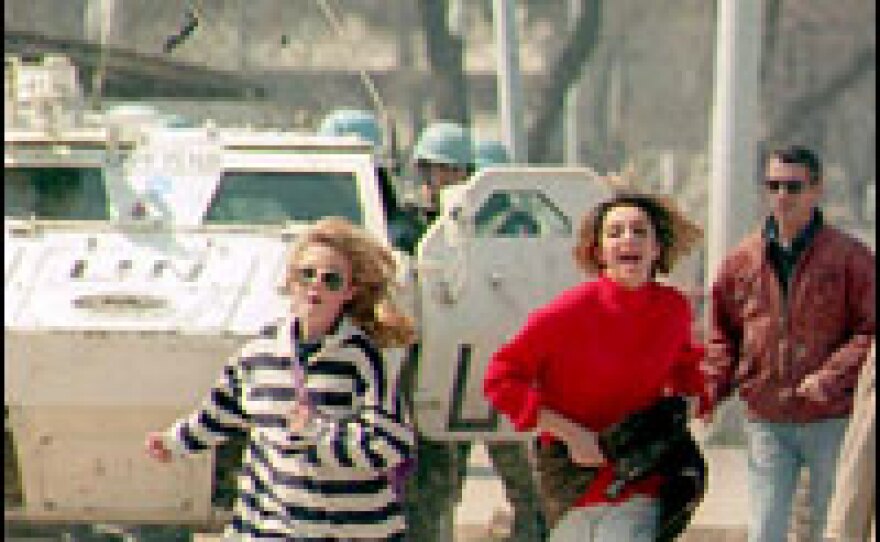 Sarajevo residents run across the Bosnian capital's "sniper alley" in April 1995, to avoid being shot at from Bosnian-Serb positions.