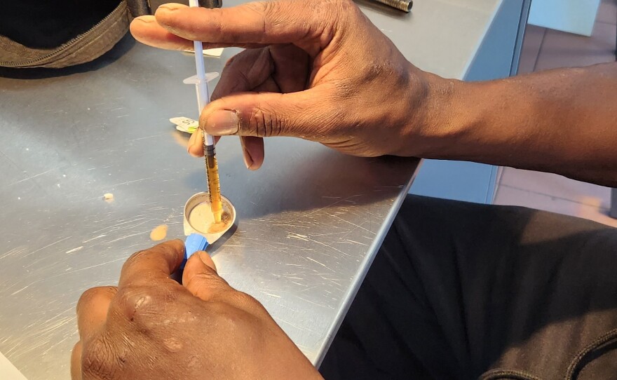 A person addicted to heroin prepares to inject at a consumption clinic in Lisbon, under the supervision of nurses. People in Portugal are 45 times less likely to die from an overdose compared with people in the U.S.