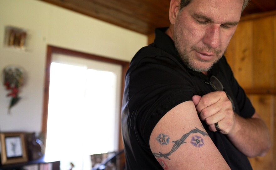 Andrew Simmons showing the tattooed the initials of all six of his adopted children on his arm in this photo taken Jan. 30, 2020. Simmons still owes San Diego County over $13,000 for the time his son spent in juvenile hall as a teen.