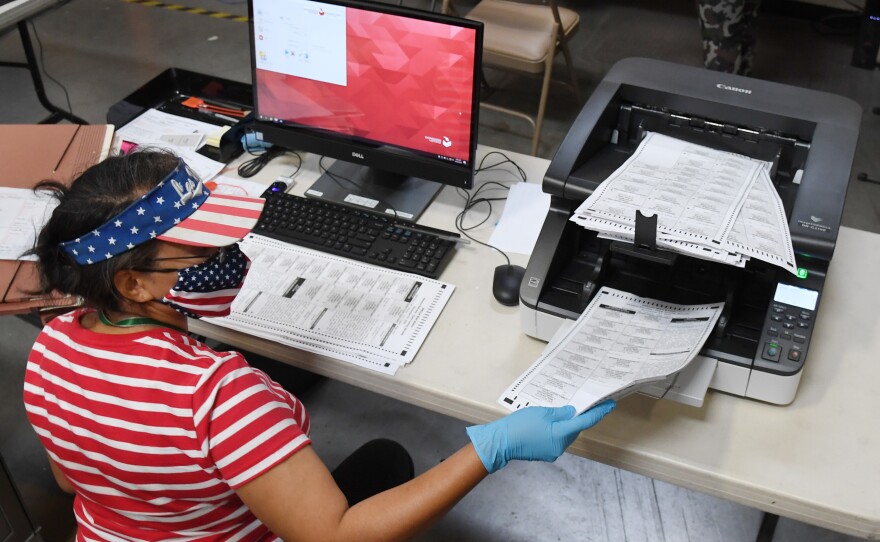 An election worker scans mail-in ballots at the Clark County Election Department on Oct. 20 in North Las Vegas, Nevada.