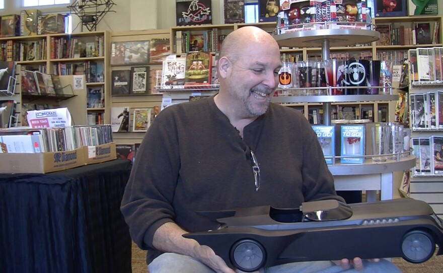 Comickaze store owner Robert Scott displays one of his favorite holiday gift ideas, a Batmobile from the "Batman" animated TV series.